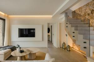 a living room with a table and a staircase at Kisterna Luxury Living in Makriótika