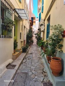 an alley with potted plants and buildings at IRIA Beach in Iria +14 photos