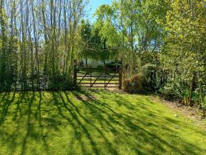 a fence in front of a yard with trees and grass at El EDEN in Mar de Cobo