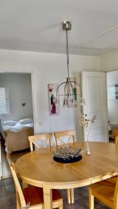 a dining room with a table and a room with a bed at Åhus Havsvillor in Åhus +8 photos
