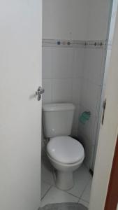 a bathroom with a white toilet in a stall at Itacimirim 3 quartos pé na areia in Camaçari +14 photos