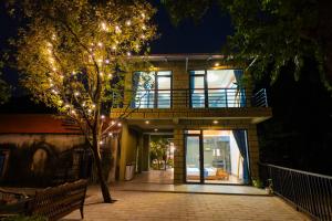a house with a balcony with lights on it at The Valley Lodge Trang An in Ninh Binh