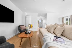 a living room with a white couch and a table at Villa Tinnum Sylt in Tinnum