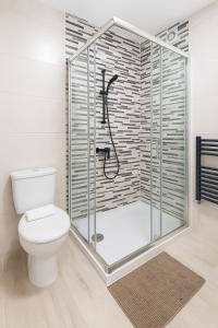 a bathroom with a shower with a toilet at Apart CityMar 24h Terraza y vistas Ria Vigo in Vigo +12 photos