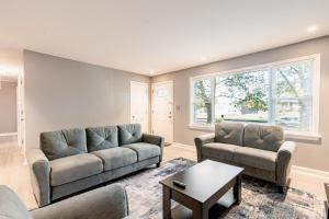 a living room with two couches and a table at 3 Bedroom home near DC in Oxon Hill