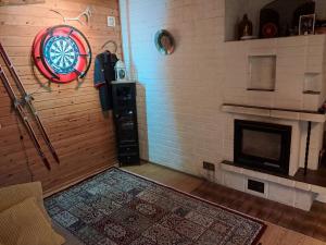 a room with a fireplace and a clock on the wall at NorthSlope in Rovaniemi