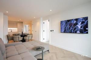 a living room with a white couch and a table at Urbano at The Heim Residences in Manchester