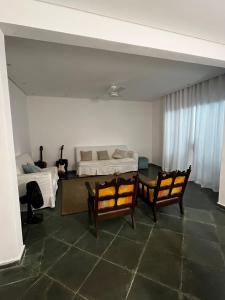 ein Schlafzimmer mit einem Bett und einem Tisch und Stühlen in der Unterkunft O refúgio perfeito para famílias in Guarujá