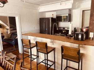 a kitchen with a bar with chairs and a counter top at Historic Home in Harpers Ferry National Park in Harpers Ferry