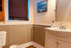 a bathroom with a sink and a toilet and a window at Historic Home in Harpers Ferry National Park in Harpers Ferry +7 photos
