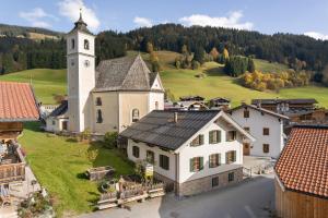 an aerial view of a church with a clock tower at Das Krämerhaus mit Sauna by Alpine Host Helpers in Kirchberg in Tirol