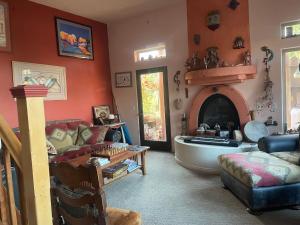 a living room with a tub and a couch and a fireplace at Mystic Canyon Inn in El Cajon