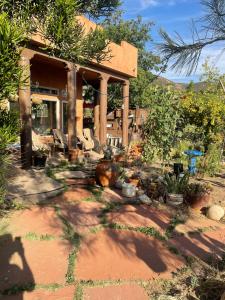 a house with chairs and plants in front of it at Mystic Canyon Inn in El Cajon