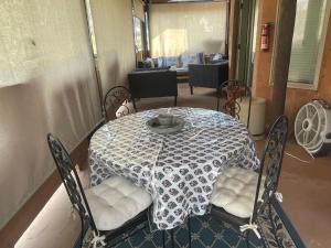 a table and chairs with a table cloth on it at Mystic Canyon Inn in El Cajon +4 photos