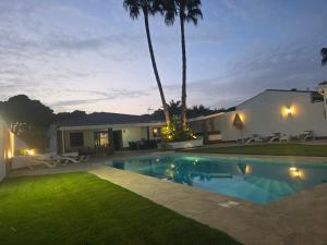 a house with a swimming pool at night at La caprichosa in Chiclana de la Frontera