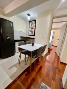 a kitchen and dining room with a table and chairs at Terrazas Cusco in Cusco
