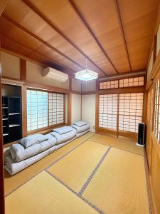 a room with four couches in a room with windows at Sky House R5 in Kawagoe