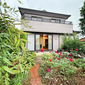 a house with a garden in front of it at Sky House R5 in Kawagoe