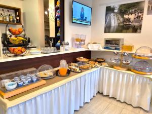 a buffet of food on a counter in a store at Hotel Mezzaluna in Treviso