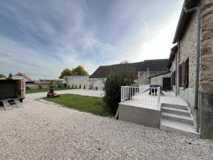 a courtyard of a building with a person sitting on the grass at L escale champenoise in Plessis-Barbuise