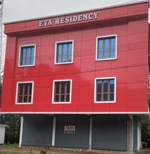 a red building with the words eva residence at EVA Residency in Kallar +7 photos