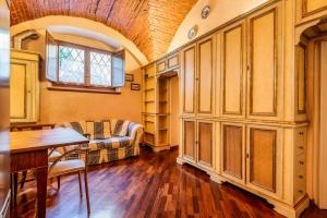 a living room with a couch and a table at Affreschi and Vintage Charm in Bergamo