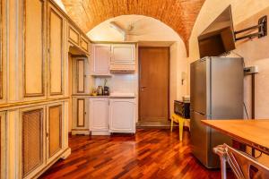 a kitchen with a stainless steel refrigerator in a room at Affreschi and Vintage Charm in Bergamo