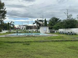 an empty swimming pool in a yard with trees at Liah's Pad in Marilao