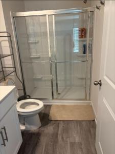a bathroom with a toilet and a glass shower at Wilson Retreat in Wilson