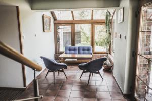 a living room with two chairs and a couch at Chata Trojkámen in Nové Losiny