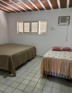 Ένα ή περισσότερα κρεβάτια σε δωμάτιο στο Casa Pé na Areia em Paripueira