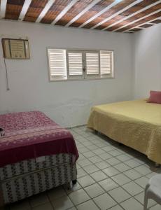 Ένα ή περισσότερα κρεβάτια σε δωμάτιο στο Casa Pé na Areia em Paripueira