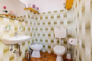 a bathroom with a white toilet and a sink at Ca’ Ruset in Roccaforte Mondovì