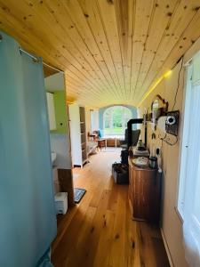 a room with a wooden ceiling and a hallway at Haevn Altes Pfarrhauss Marienfliess in Stepenitz