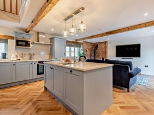 an open kitchen and living room with a large island at 1 Bed in Scaleby 94538 in Scaleby