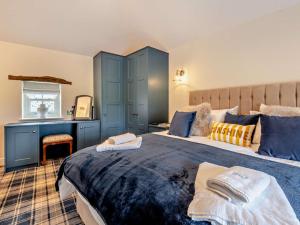 a bedroom with two beds with blue cabinets at 1 Bed in Scaleby 94538 in Scaleby
