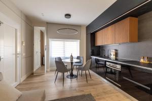 a kitchen and dining room with a table and chairs at Charming & Luxurious Suite Garibaldi BIG - Fully equipped & renovated - Old Town in Olbia