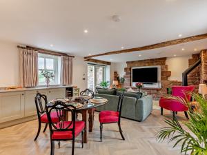 a living room with a table and chairs and a couch at 2 Bed in Scaleby 96302 in Scaleby