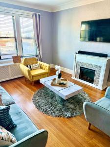 a living room with a couch and a fireplace at The Basquiat Suite in East Orange
