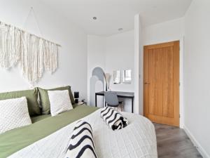 a bedroom with a bed and a desk and a door at Opal Residence City Centre in Leicester