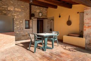 a table and chairs on a brick patio at Fattoria degli Usignoli in San Donato in Fronzano