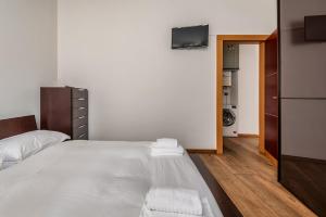 a bedroom with a bed with towels on it at Città alta Apartment-comfort in Bergamo +11 photos