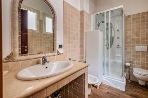 a bathroom with a sink and a shower and a toilet at Città alta Apartment-comfort in Bergamo