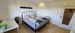 a bedroom with a black bed with pillows and a table at HeideAway im Waldviertel in Langschlag