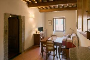 a kitchen and living room with a table and a couch at Residenza Antica Canonica in Città di Castello