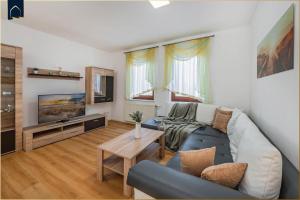 a living room with a couch and a tv at 257 Haus Otto in Ahlbeck