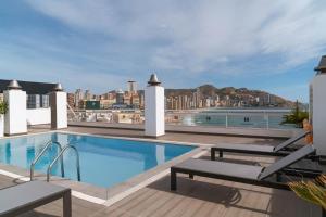 a swimming pool on the roof of a building at Limehome Benidorm Calle Mayor in Benidorm