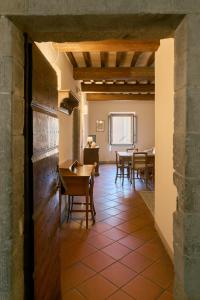 a hallway with a table and chairs in a room at Residenza Antica Canonica in Città di Castello