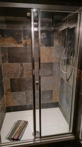 a shower with a glass door in a bathroom at The Studio at St Cleer in Chippenham