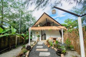 a small house with a pathway leading to it at Luna and Sol Beach Resort in Zambales